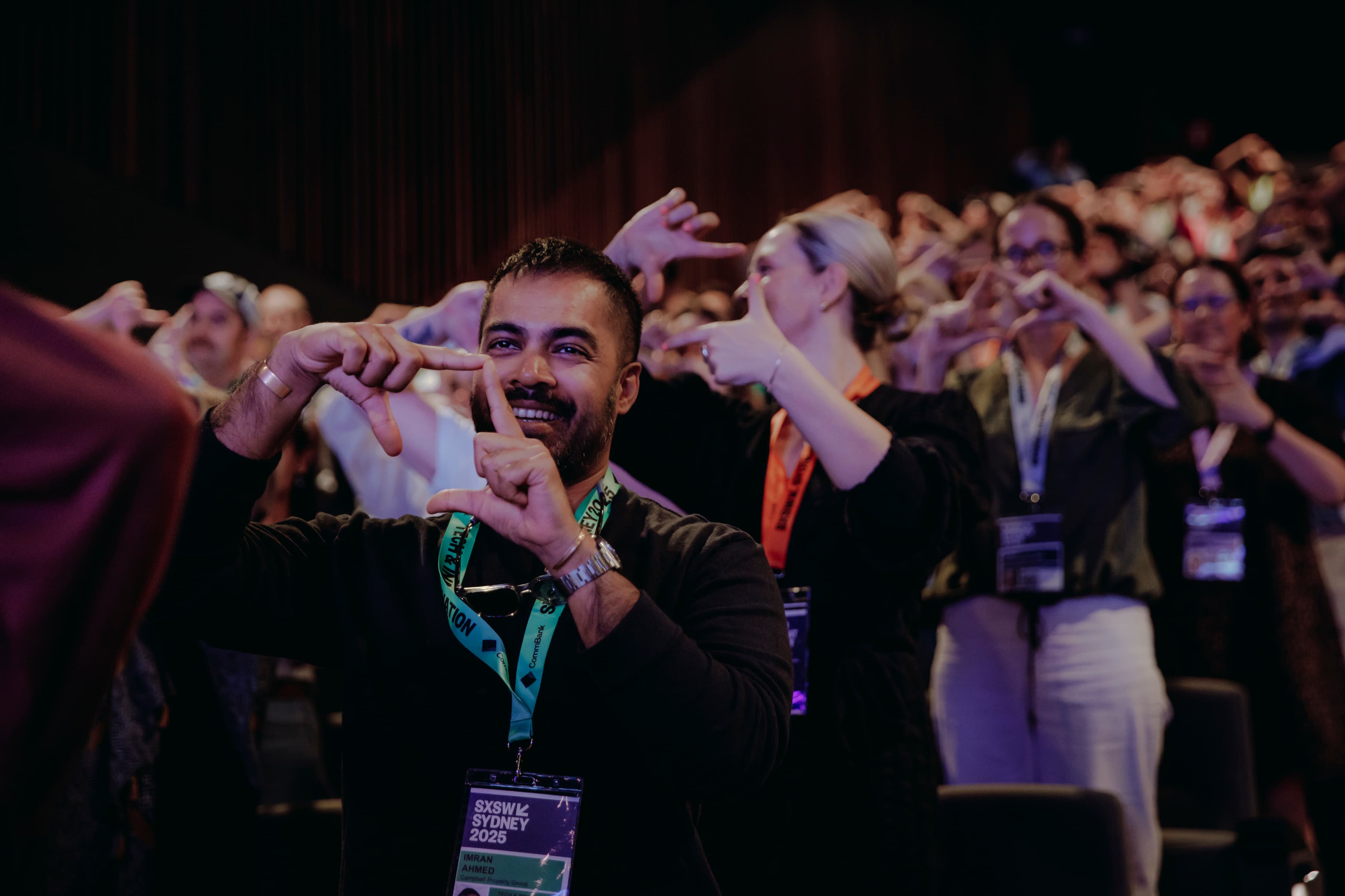 Practitioners at Frederik's keynote making photographer-frame gestures with their hands